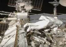 Spacewalk disconnects cables on mating adaptor ready for its move